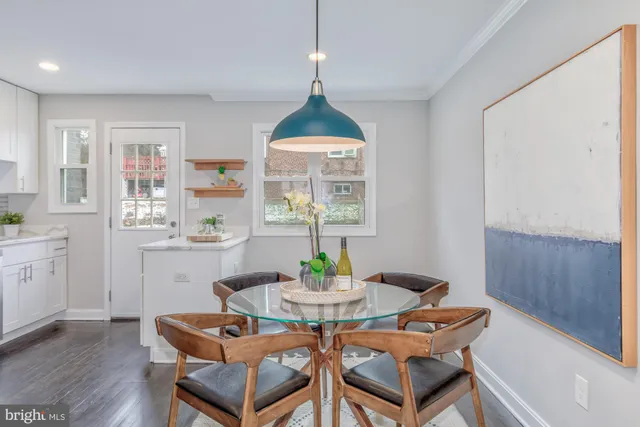 a dining room with furniture a window and a chandelier