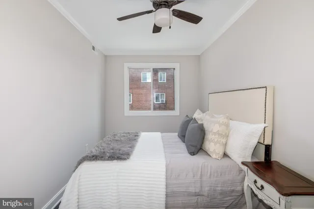 a bedroom with a bed and window