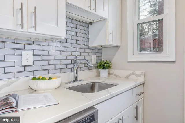 a bathroom with a sink and a window
