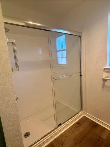 a bathroom with a glass shower door