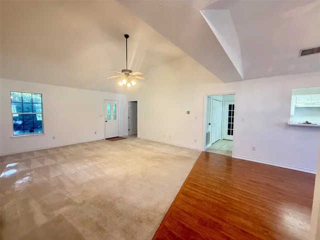 a view of a room with a chandelier fan