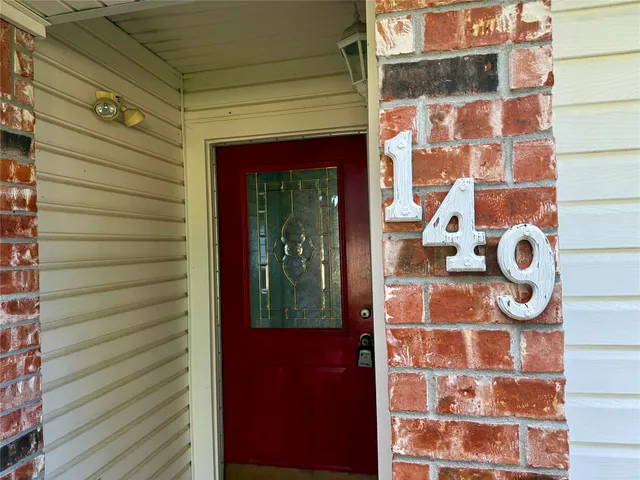 a view of a door and brick wall