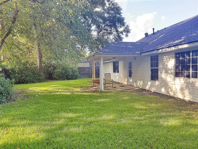 a backyard of a house with yard table and chairs
