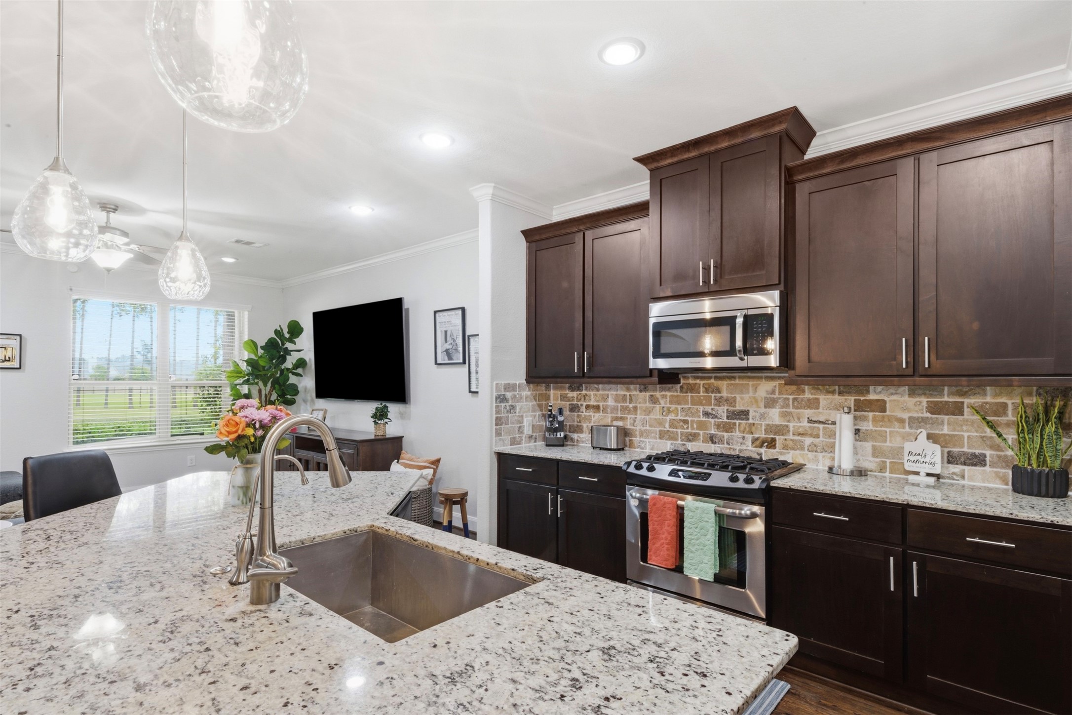 706 Water Street Webster, TX 77598 - Photo 8 of 23 Thoughtful details like under-cabinet lighting and generous storage keep everything within reach yet out of sight.