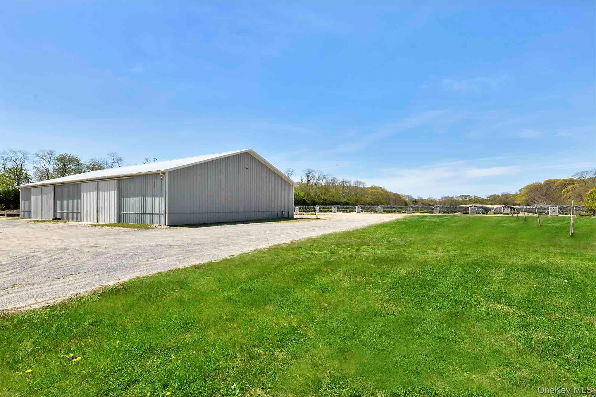 935 Franklinville Road Laurel, NY 11948 - Photo 7 of 11 View of pole building with a yard