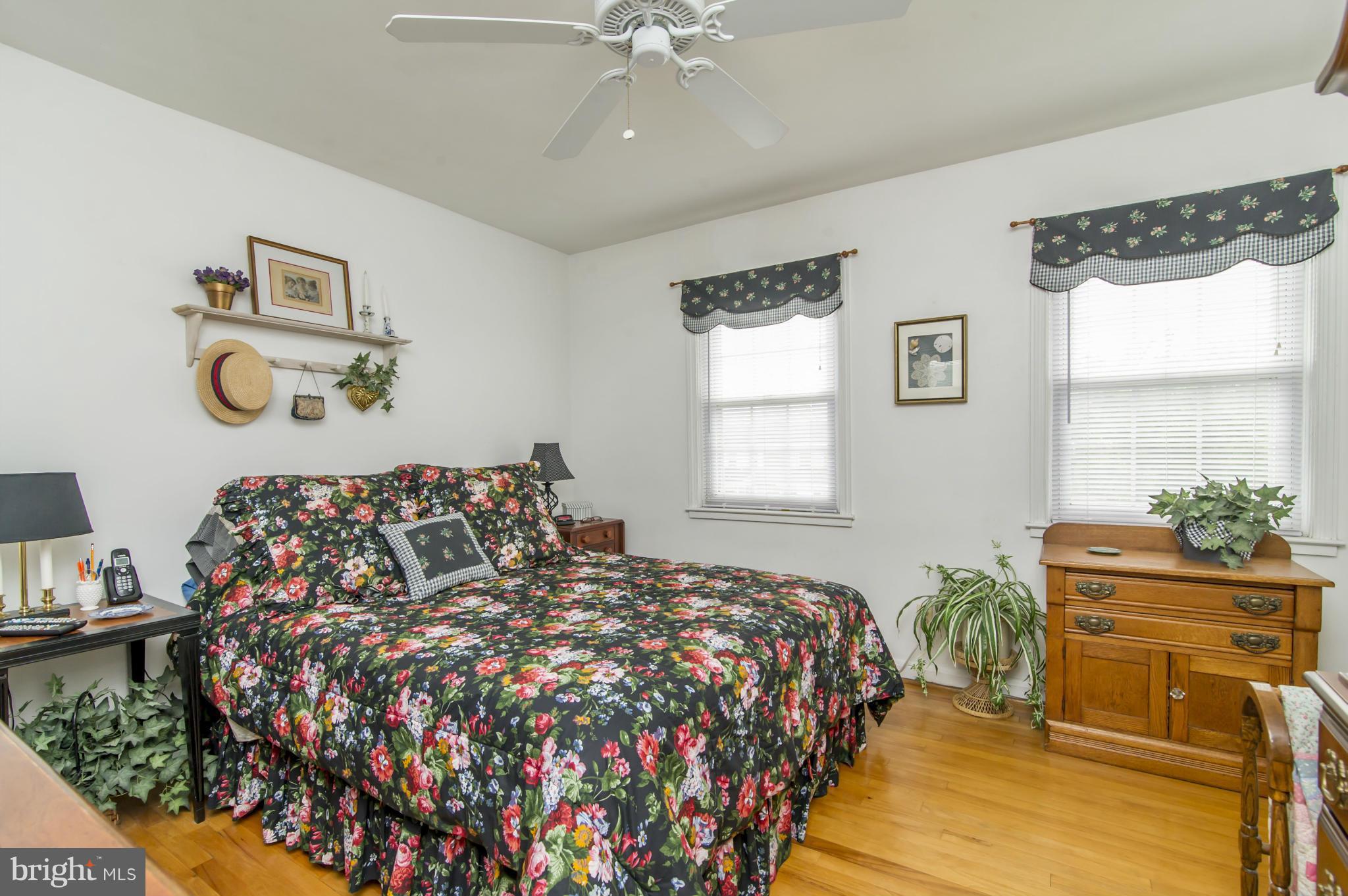 6906 Broening Road Dundalk, MD 21222 - Photo 13 of 29 a bedroom with a bed and wooden floor