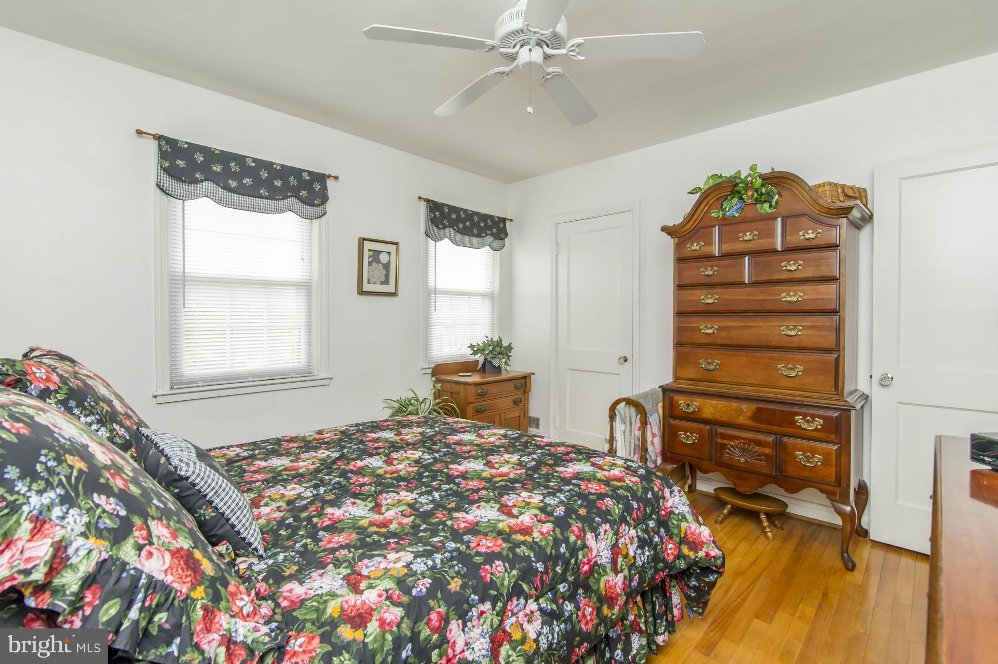 6906 Broening Road Dundalk, MD 21222 - Photo 14 of 29 a bedroom with a bed and a chandelier