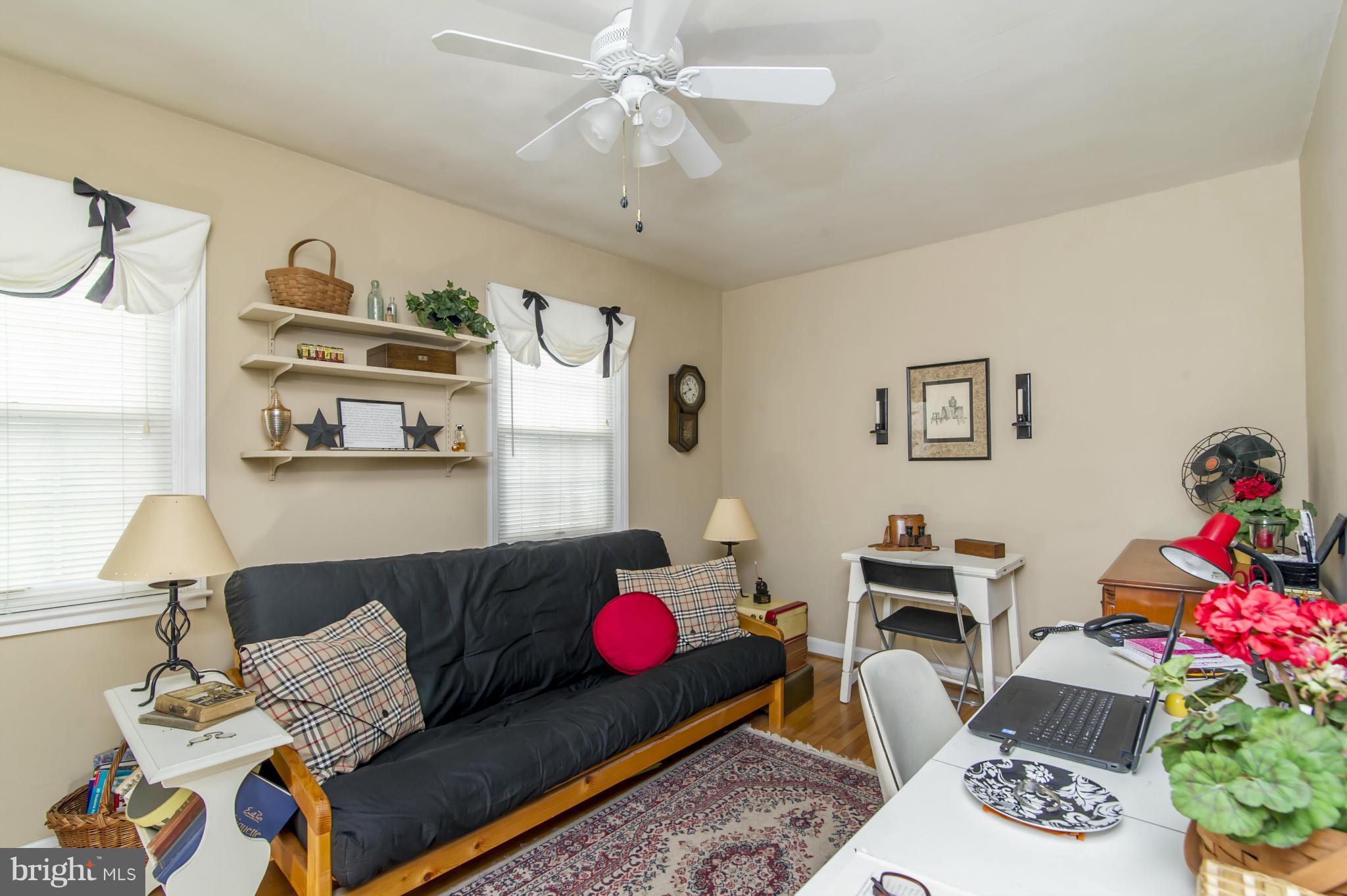 6906 Broening Road Dundalk, MD 21222 - Photo 15 of 29 a living room with furniture and flowers