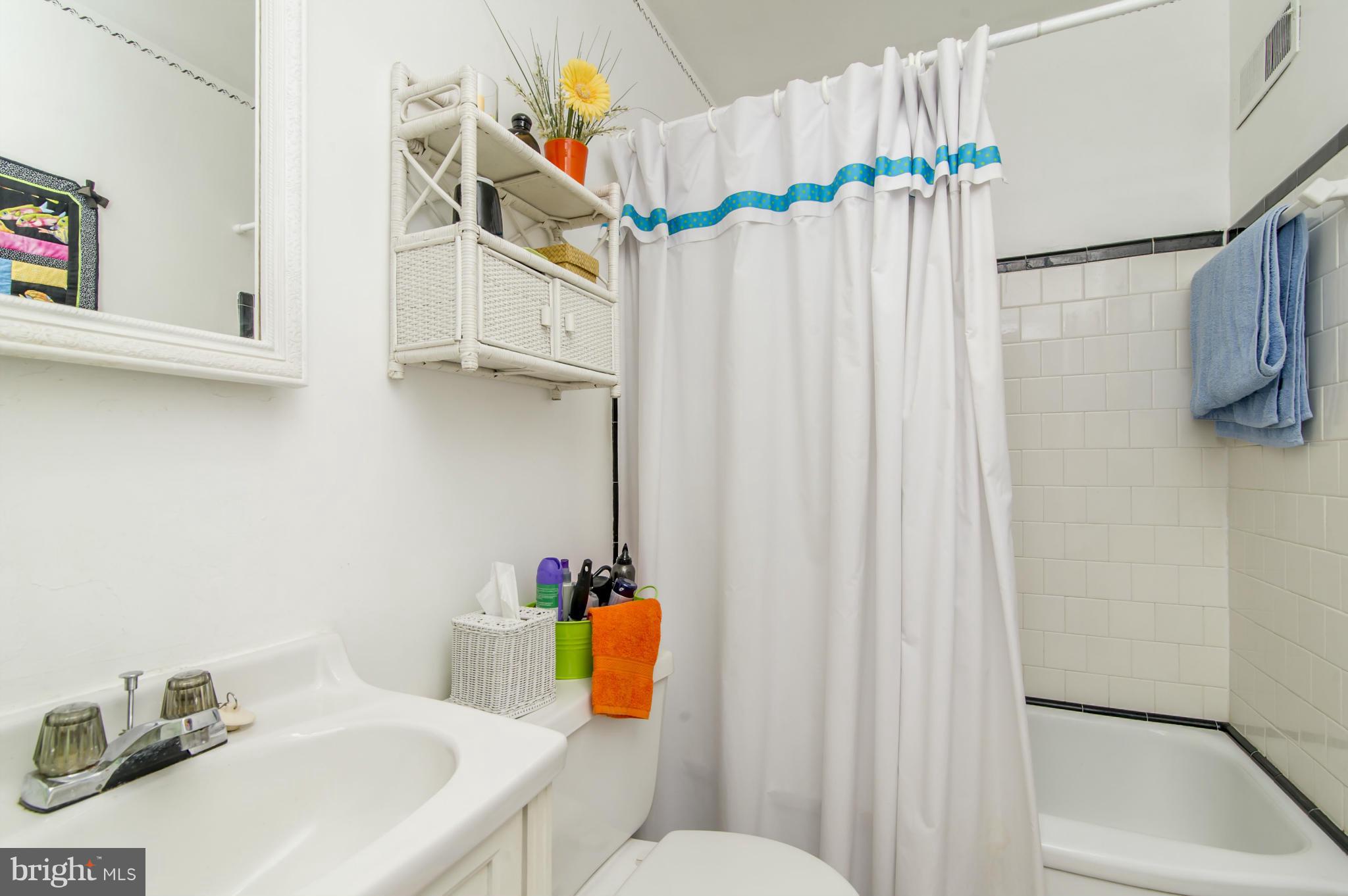 6906 Broening Road Dundalk, MD 21222 - Photo 19 of 29 a bathroom with a sink and a shower curtain