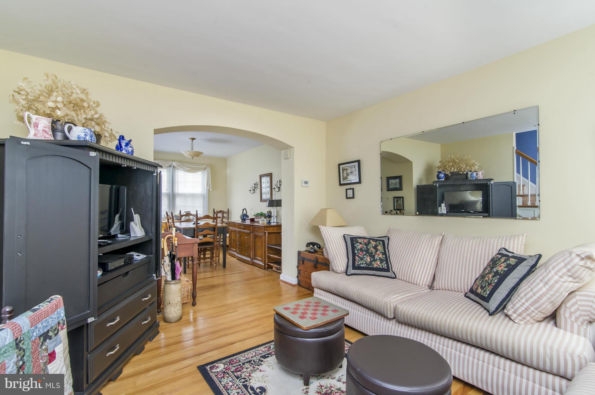6906 Broening Road Dundalk, MD 21222 - Photo 4 of 29 a living room with furniture and a dining table with wooden floor