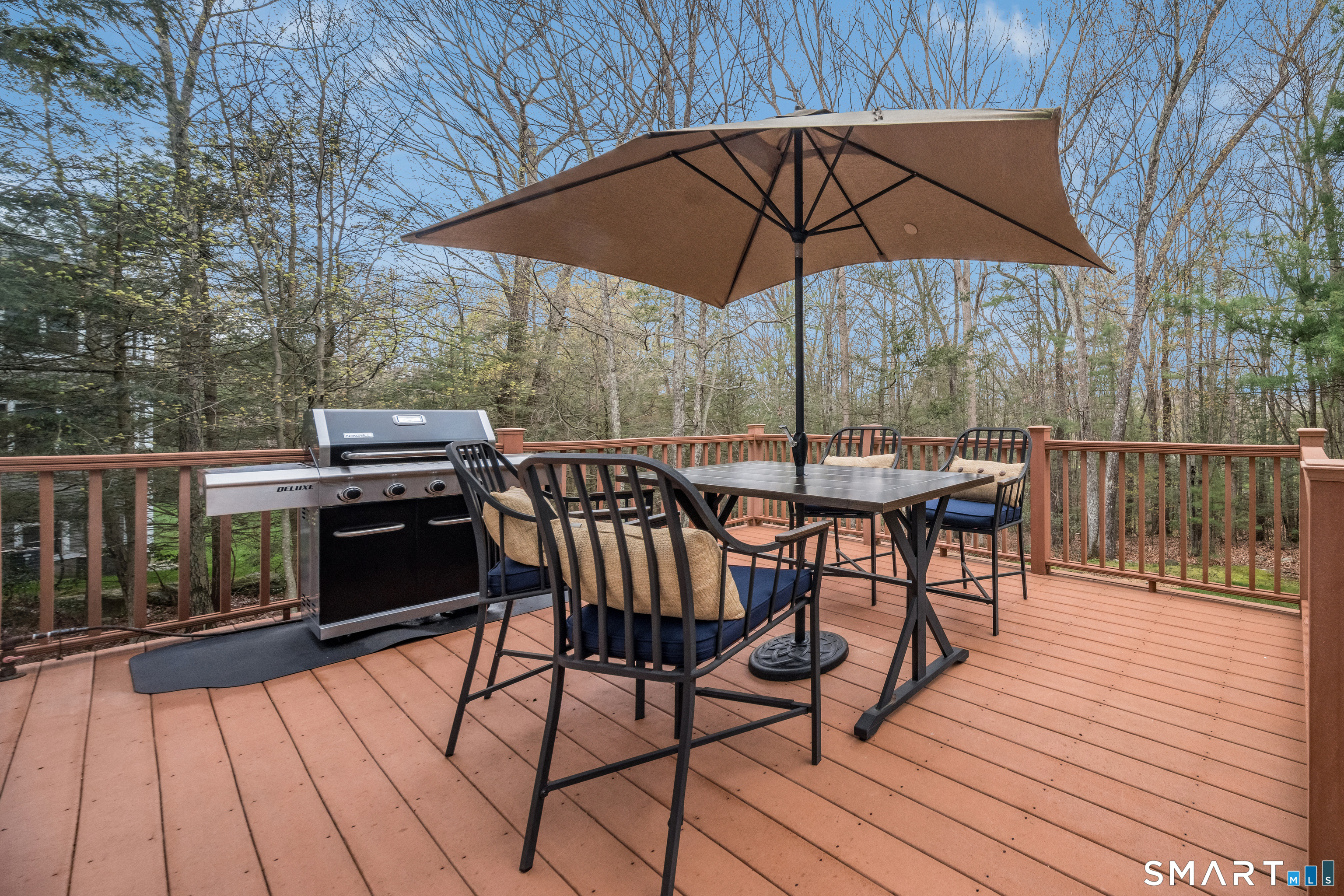 4 Collins View Road Canton, CT 06019 - Photo 11 of 38 a view of a roof deck with table and chairs under an umbrella