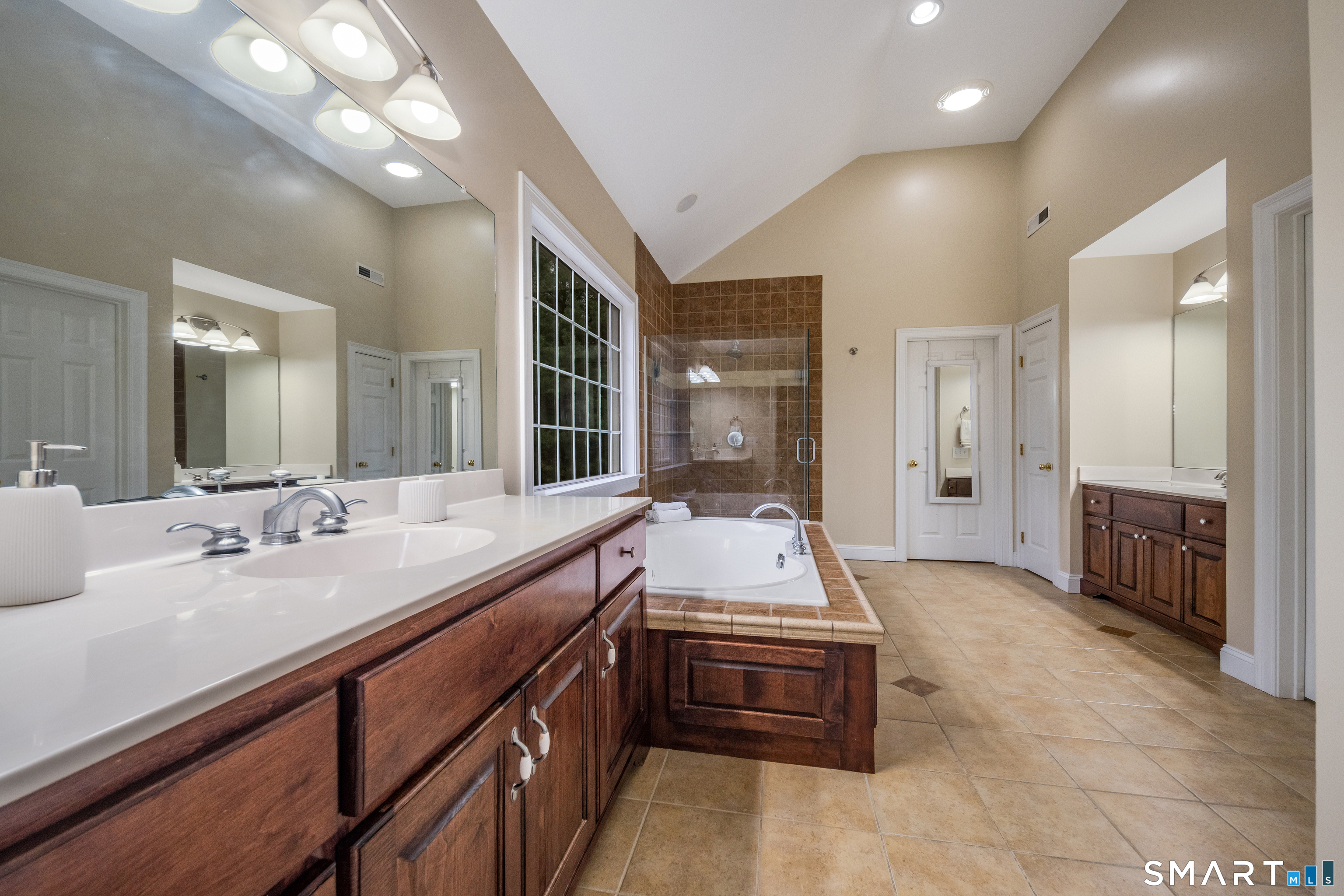 4 Collins View Road Canton, CT 06019 - Photo 20 of 38 a spacious bathroom with a double vanity sink a large mirror and a shower