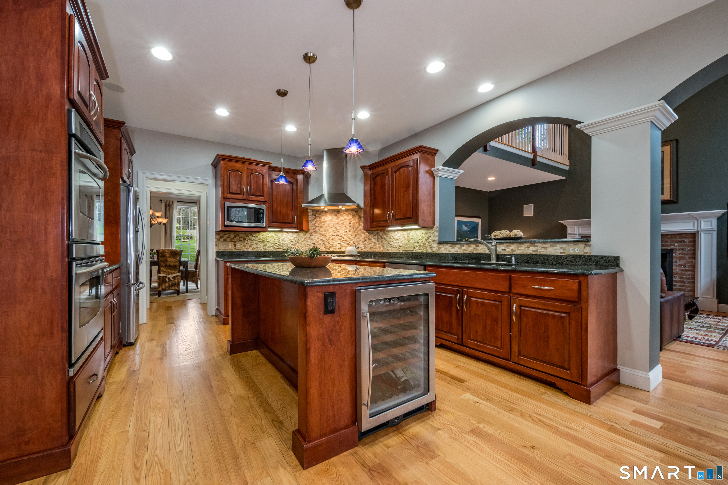 4 Collins View Road Canton, CT 06019 - Photo 5 of 38 a kitchen with kitchen island granite countertop wooden floors and a sink