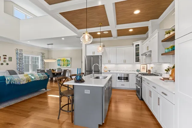 a large kitchen with lots of counter space a sink a window and chairs