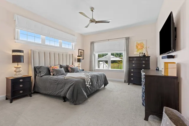 a spacious bedroom with a bed and a flat screen tv