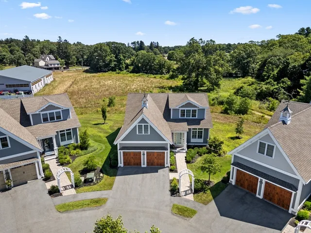 an aerial view of a house with swimming pool and garden