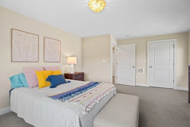 a bedroom with a bed and painting on the wall