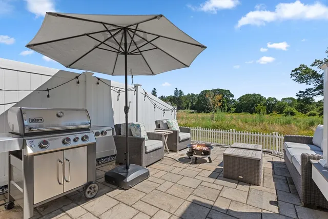 a view of a patio with couches under an umbrella