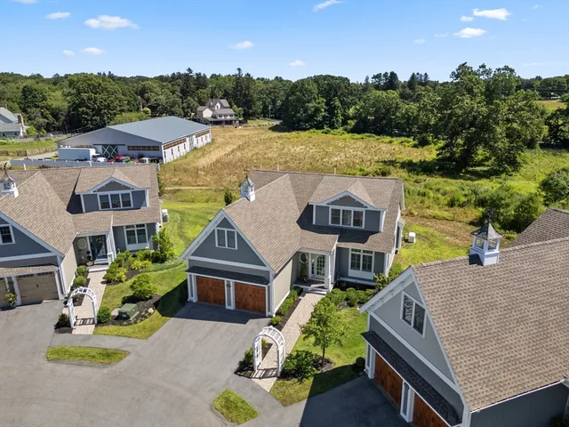 an aerial view of a house with swimming pool and garden