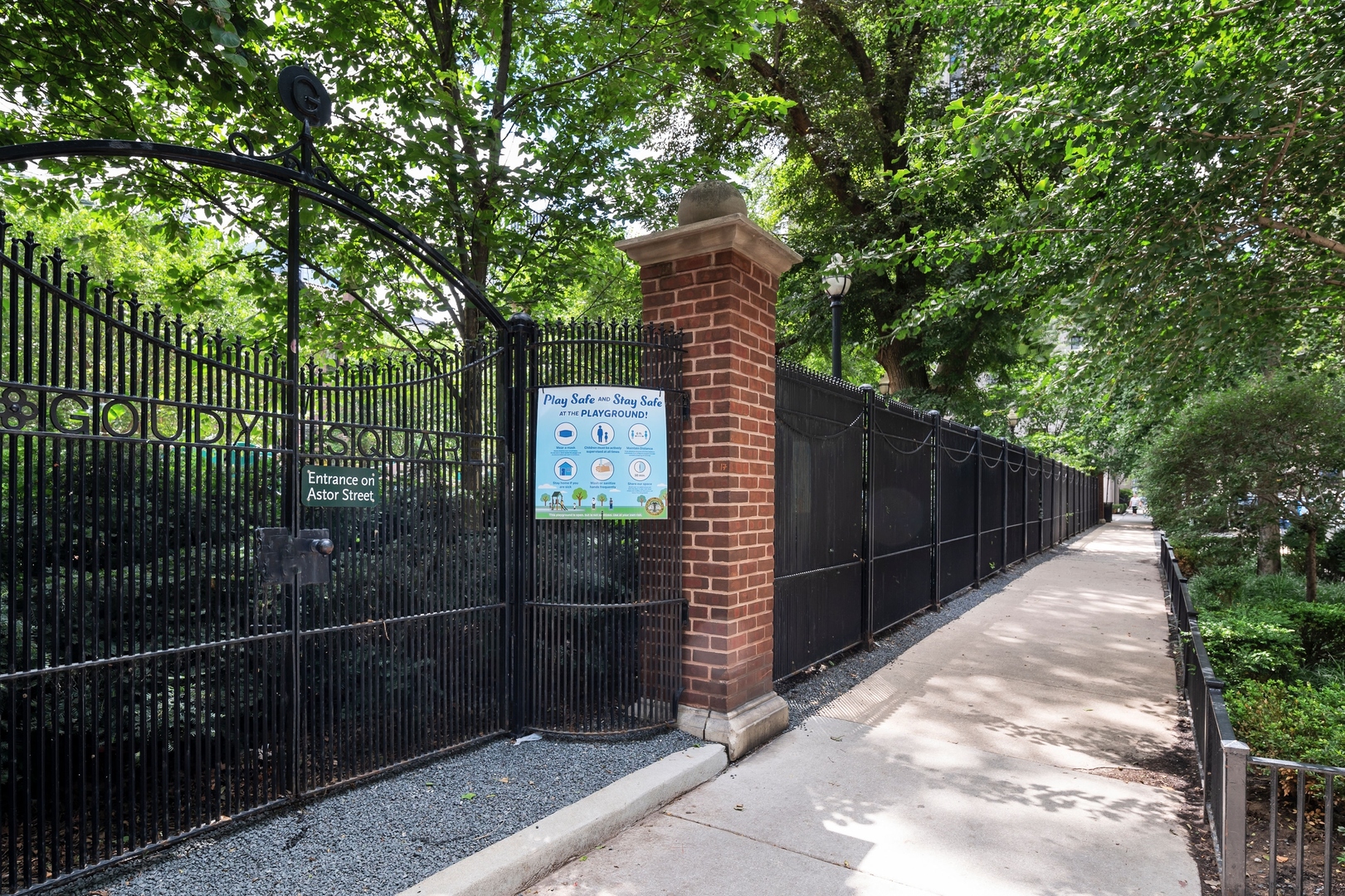 1260 North Astor Street, Unit 8 Chicago, IL 60610 - Photo 26 of 27 a wooden fence and trees in the background