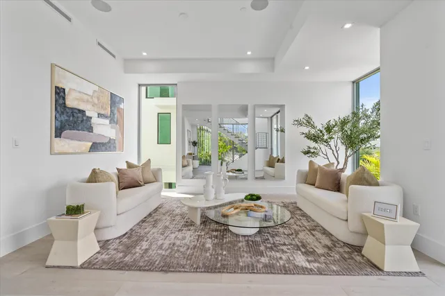 a hallway with white cabinets and window