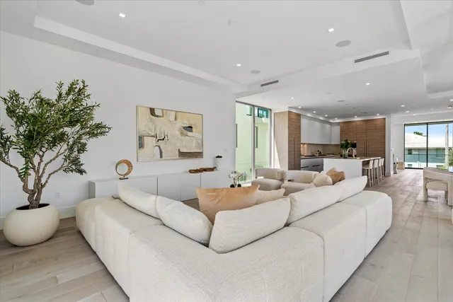 a kitchen with kitchen island a wooden floor and white cabinets