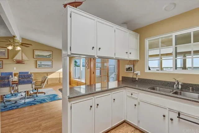 a kitchen with stainless steel appliances granite countertop a sink and cabinets