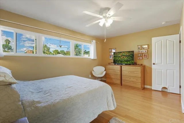 a bedroom with a bed and a painting on the wall