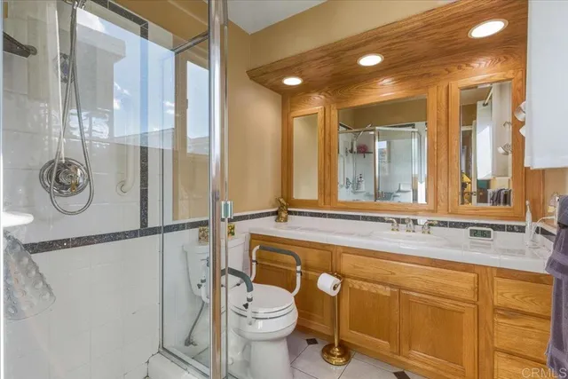 a bathroom with a granite countertop sink mirror vanity and toilet