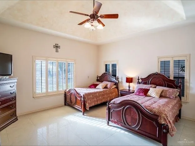 a bedroom with two beds and a chandelier