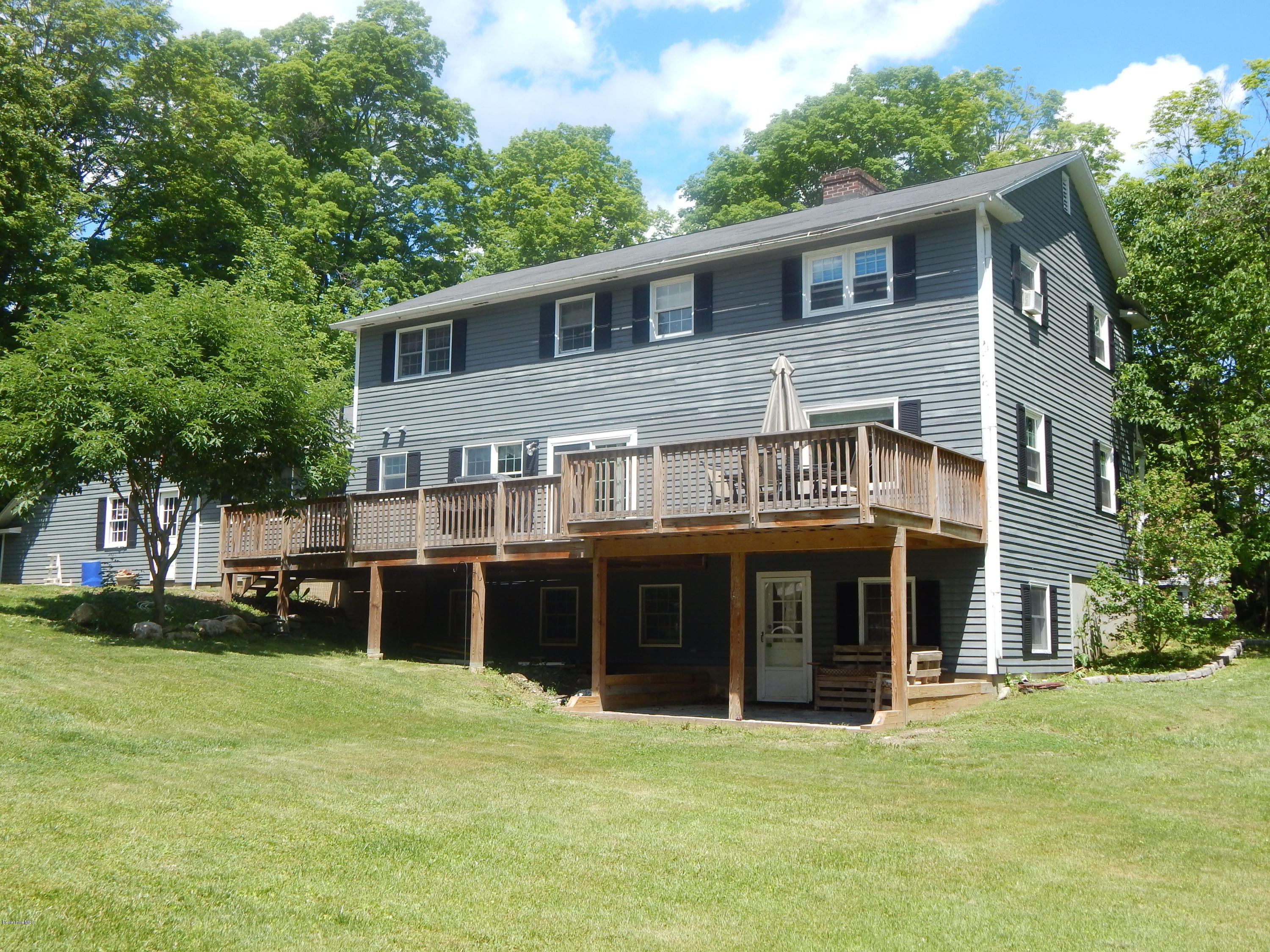 425 Devon Road Lee, MA 01238 - Photo 2 of 35 a big house with a big yard and large trees