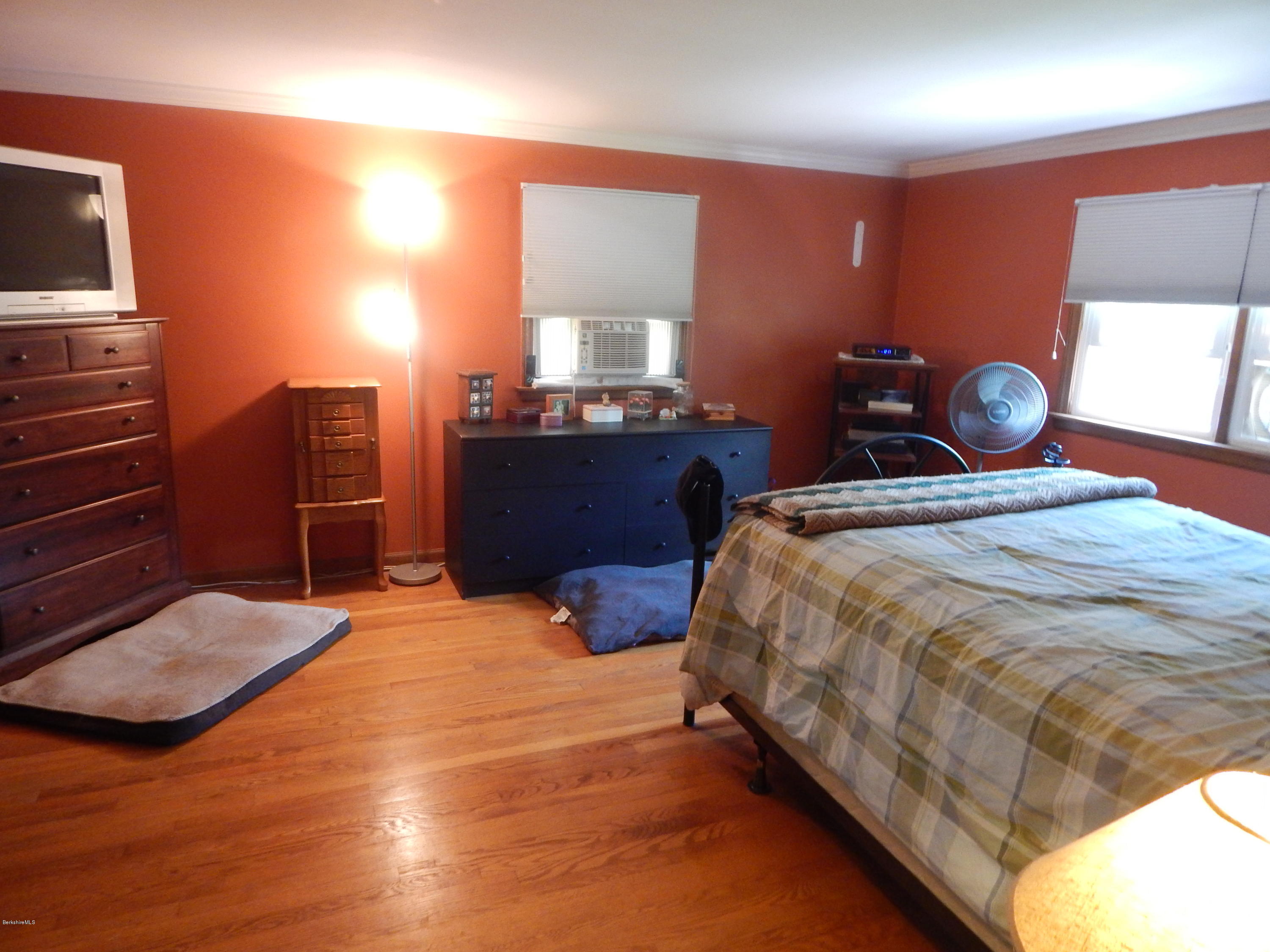 425 Devon Road Lee, MA 01238 - Photo 14 of 35 a bedroom with a bed and dresser with wooden floor