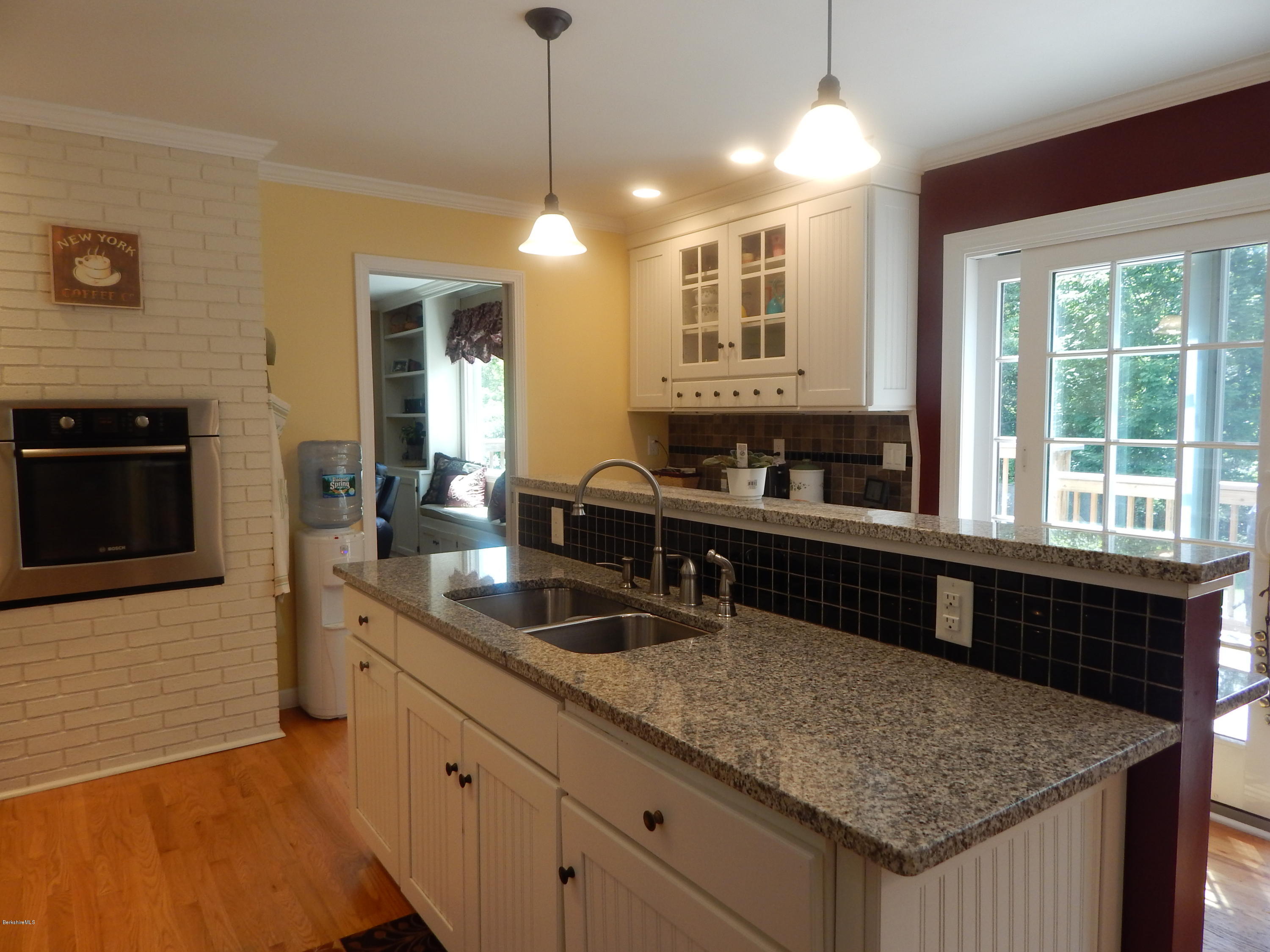 425 Devon Road Lee, MA 01238 - Photo 3 of 35 a kitchen with granite countertop a sink and a window