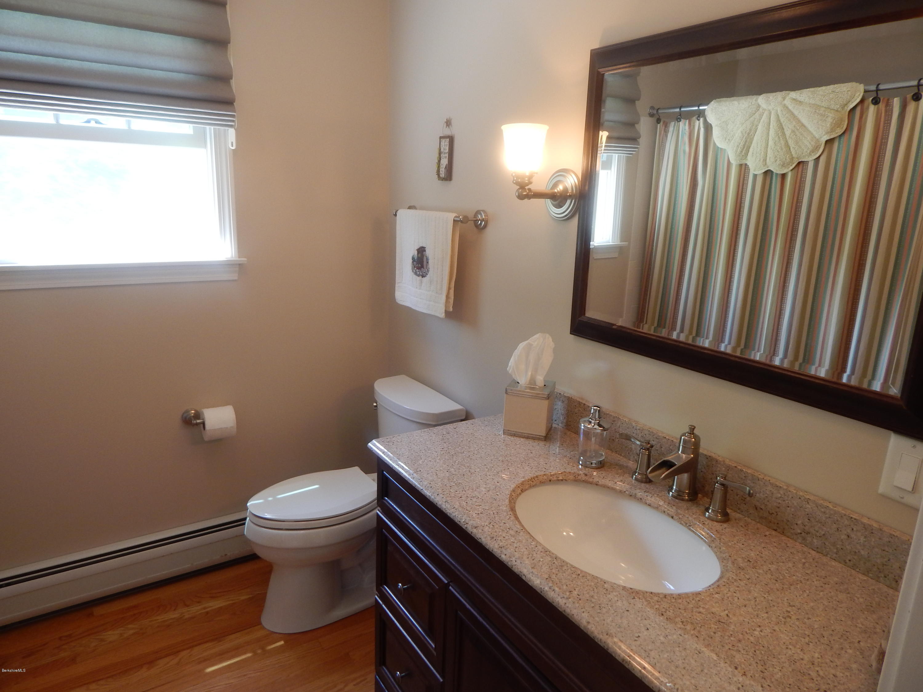 425 Devon Road Lee, MA 01238 - Photo 22 of 35 a bathroom with a granite countertop sink toilet and mirror