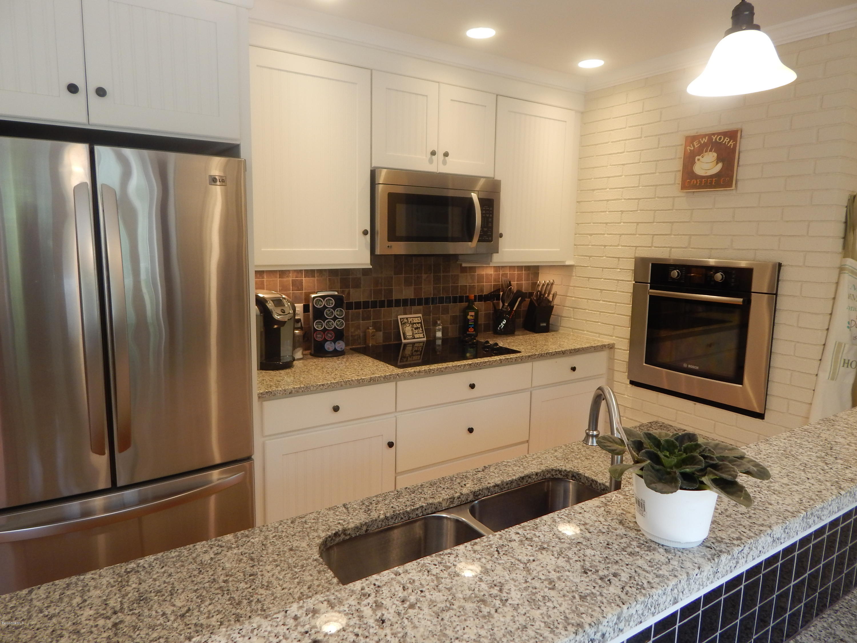 425 Devon Road Lee, MA 01238 - Photo 4 of 35 a kitchen with stainless steel appliances granite countertop a refrigerator a stove and a sink