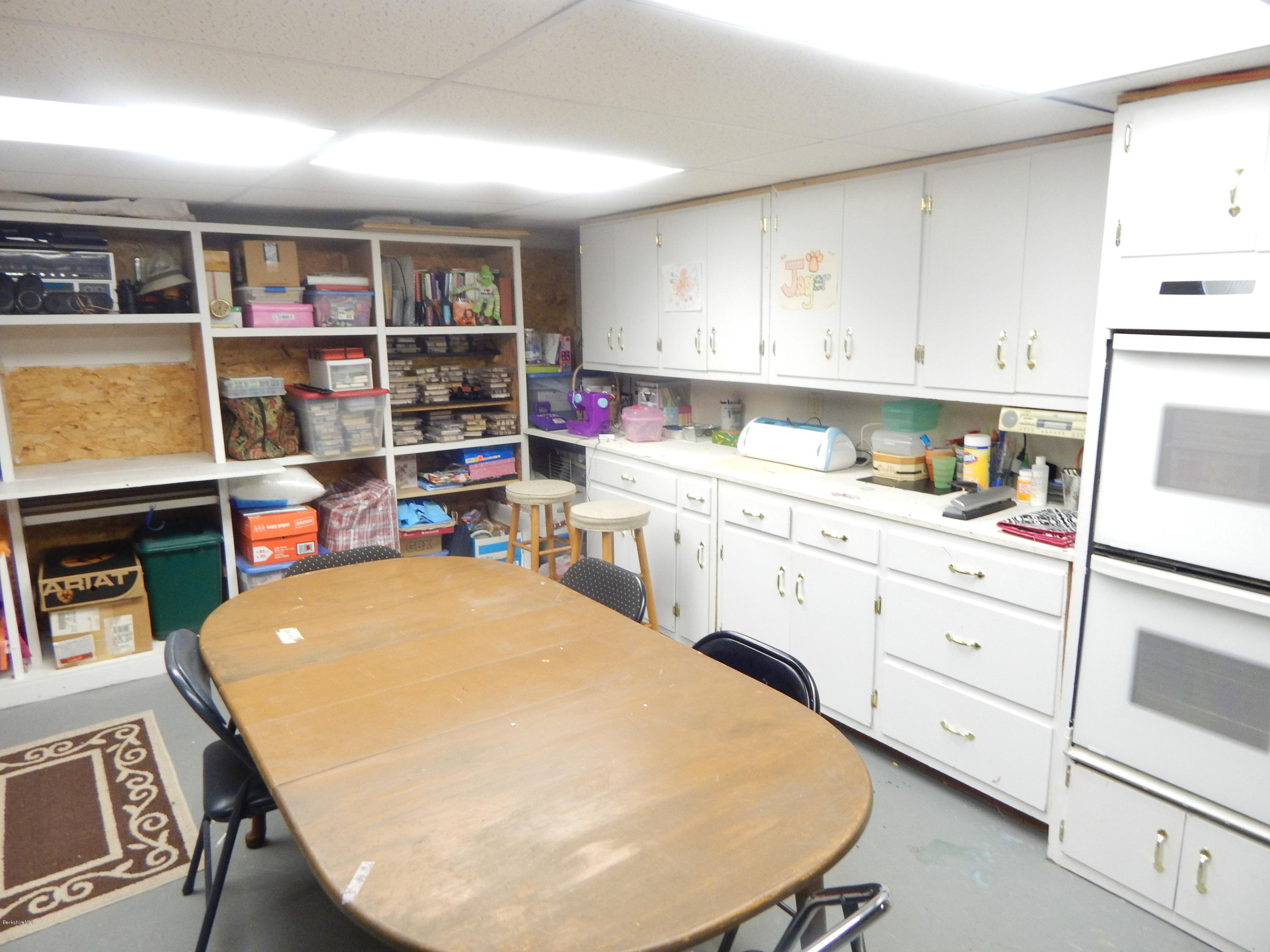 425 Devon Road Lee, MA 01238 - Photo 34 of 35 a room with a white cabinets a stove a sink and a refrigerator
