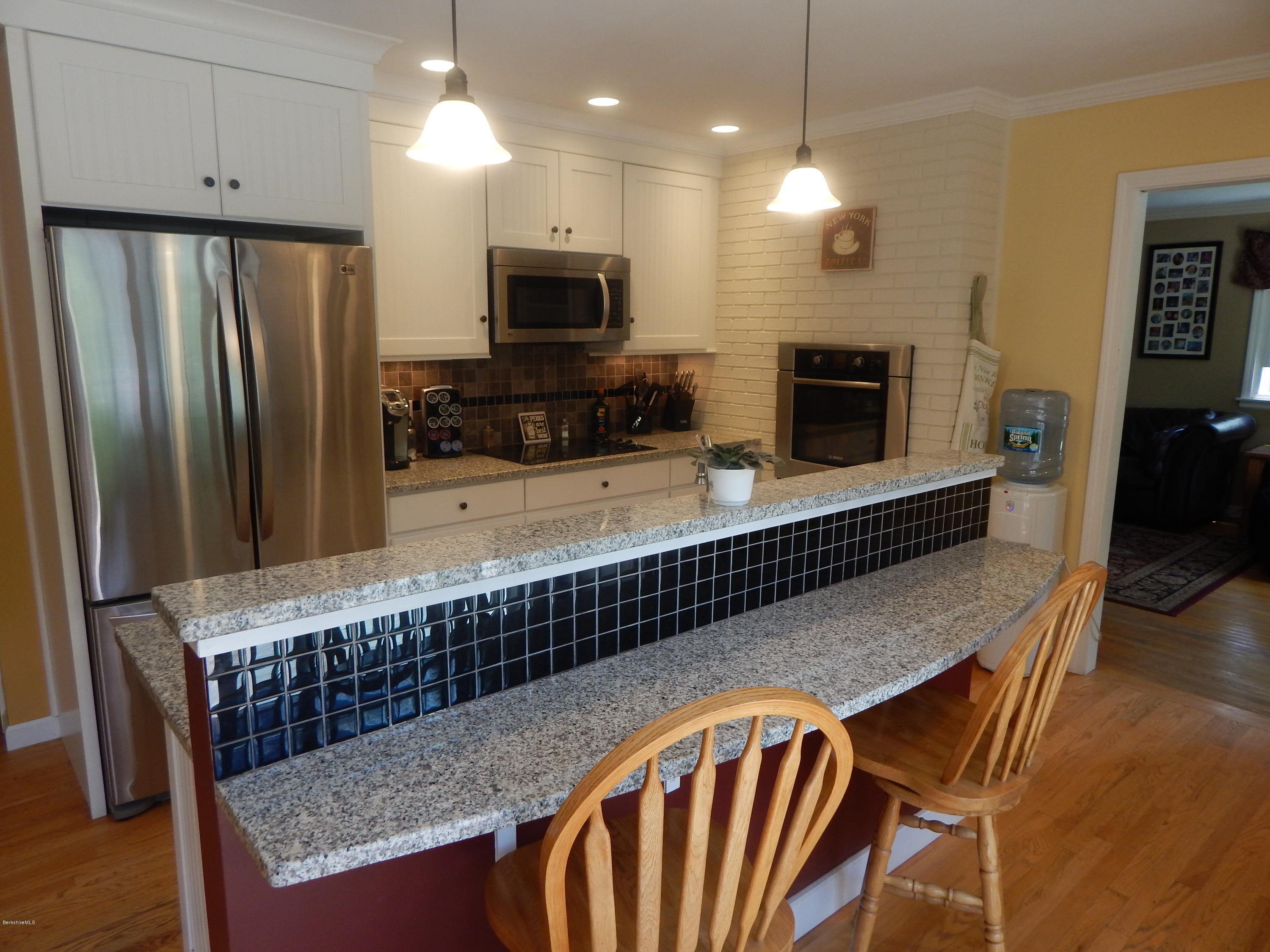 425 Devon Road Lee, MA 01238 - Photo 5 of 35 a kitchen with stainless steel appliances granite countertop a stove microwave and sink