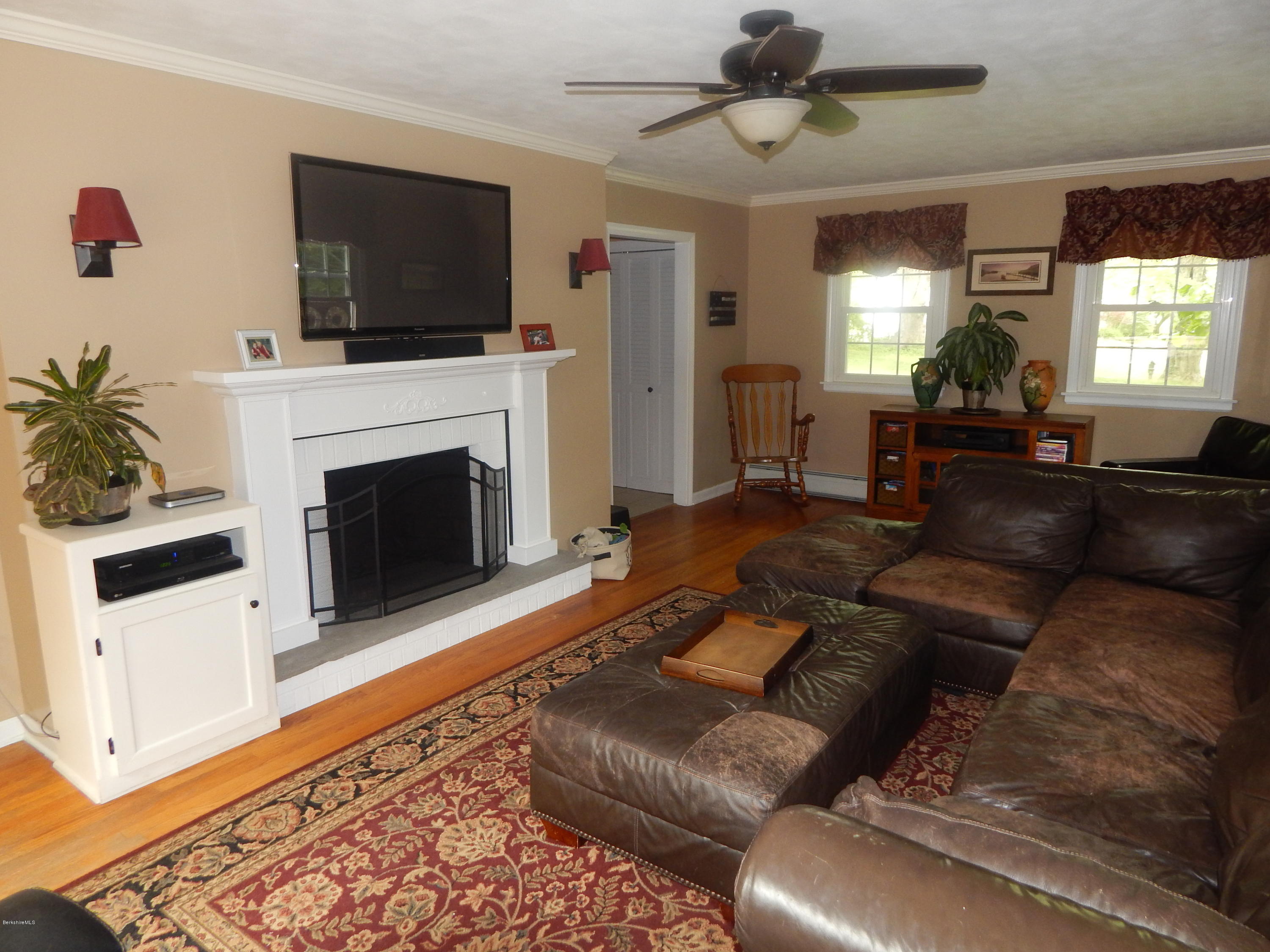 425 Devon Road Lee, MA 01238 - Photo 9 of 35 a living room with furniture a fireplace and a flat screen tv