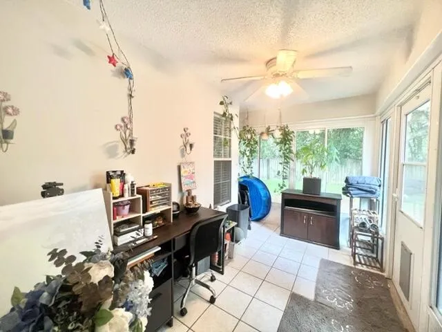 a living room with furniture a flat screen tv and a floor to ceiling window
