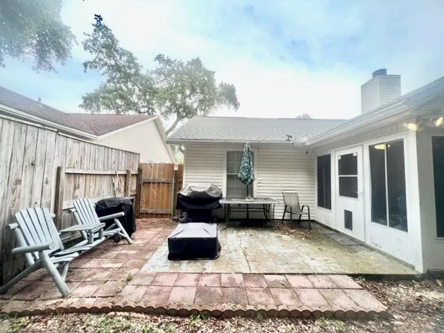 a view of a patio with furniture and a rug
