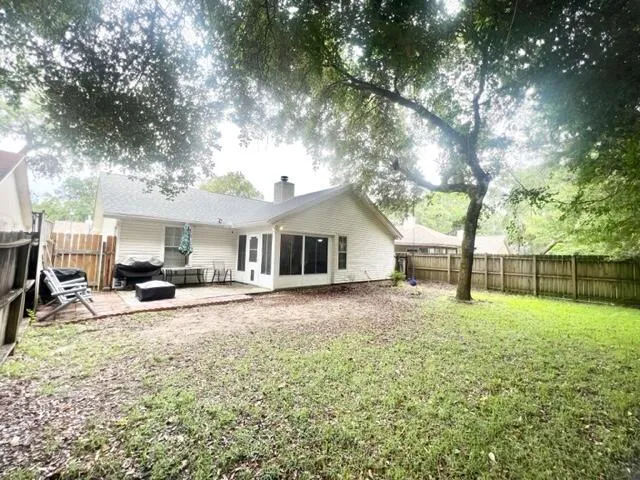 a view of a house with backyard and sitting area