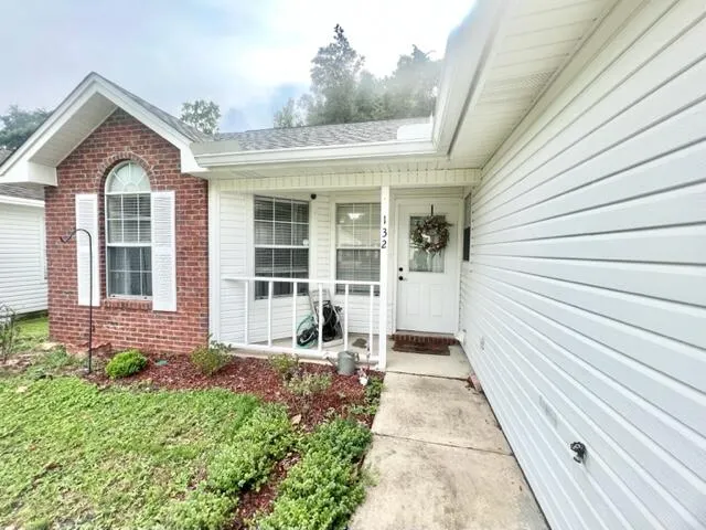a view of a brick house with many windows