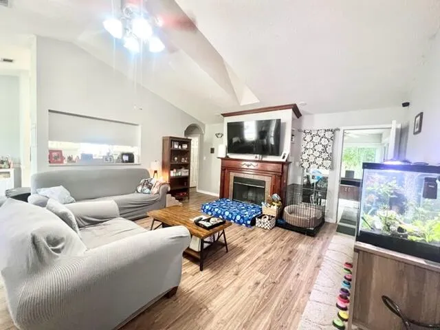 a living room with furniture fireplace and flat screen tv