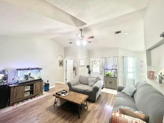 a living room with furniture and wooden floor