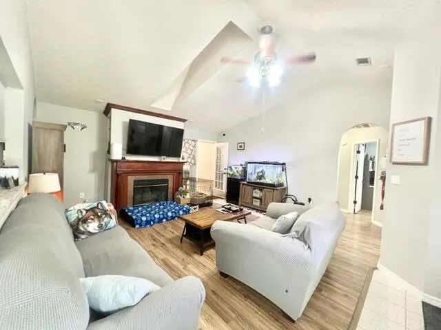 a living room with furniture a fireplace and a flat screen tv