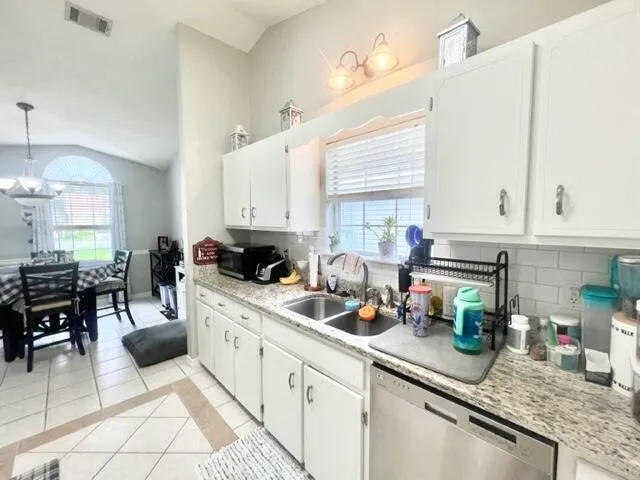 a kitchen with sink cabinets and window