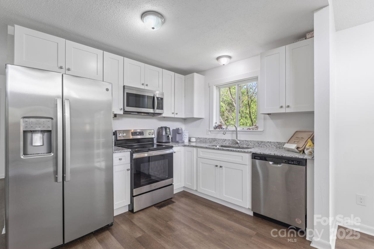 2403 Earley Circle Kannapolis, NC 28083 - Photo 6 of 21 a kitchen with stainless steel appliances granite countertop a stove a sink and a refrigerator