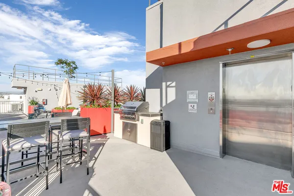 a view of a patio with table and chairs