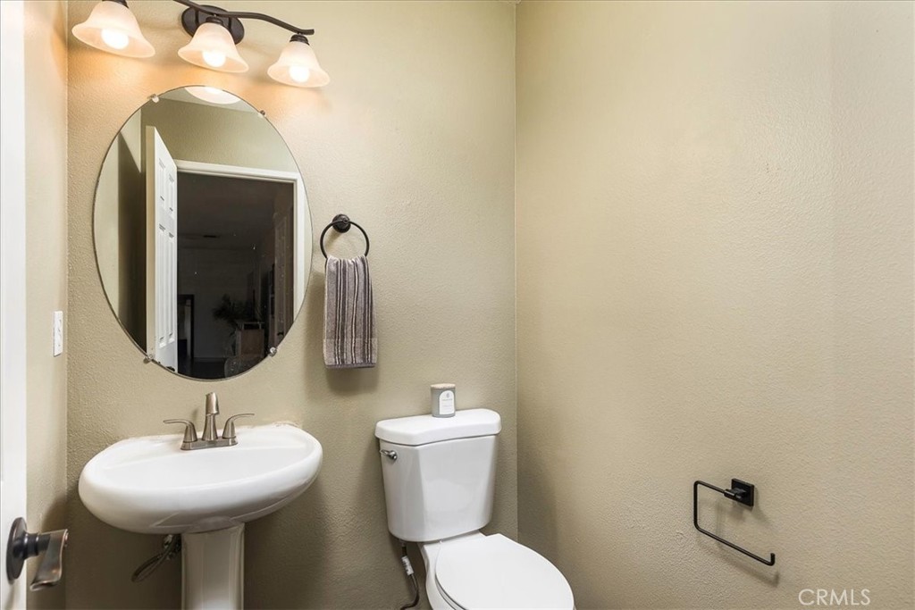 42064 Pine Needle Street Temecula, CA 92591 - Photo 14 of 39 a bathroom with a toilet sink and mirror