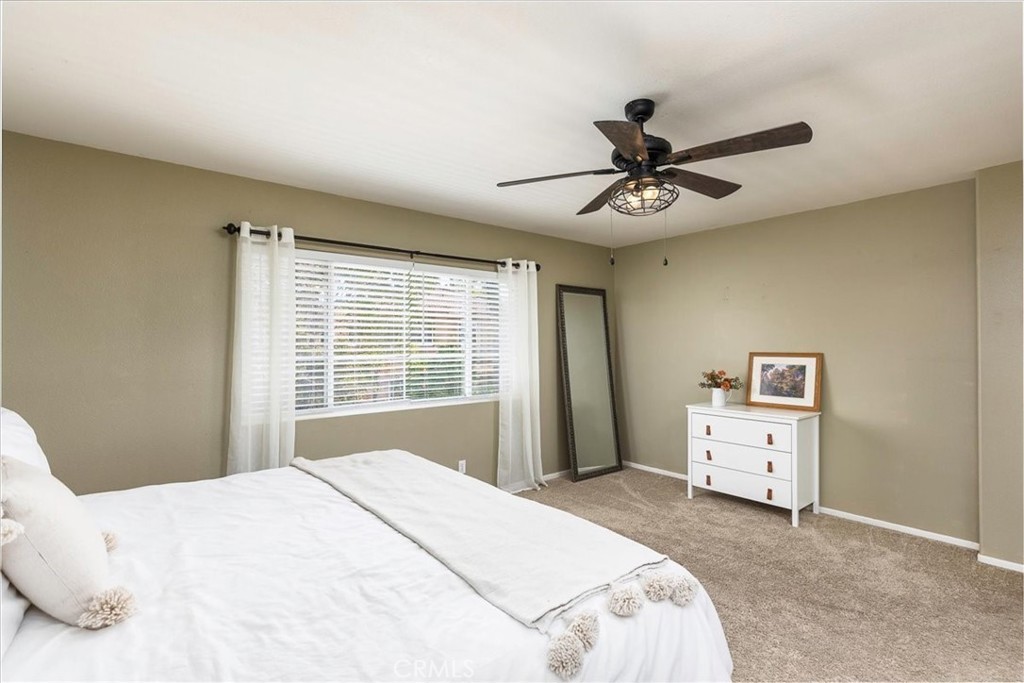 42064 Pine Needle Street Temecula, CA 92591 - Photo 15 of 39 a bedroom with a bed and a chandelier